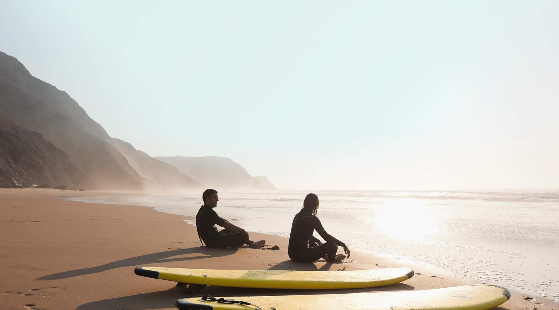 two surfers resting on Donegal beach