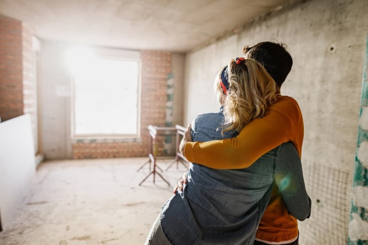 couple hugging in living room process of renovation