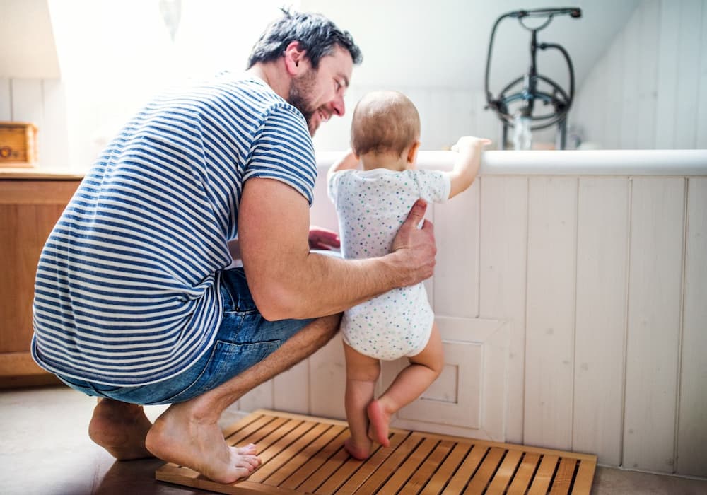 father minding baby from bath