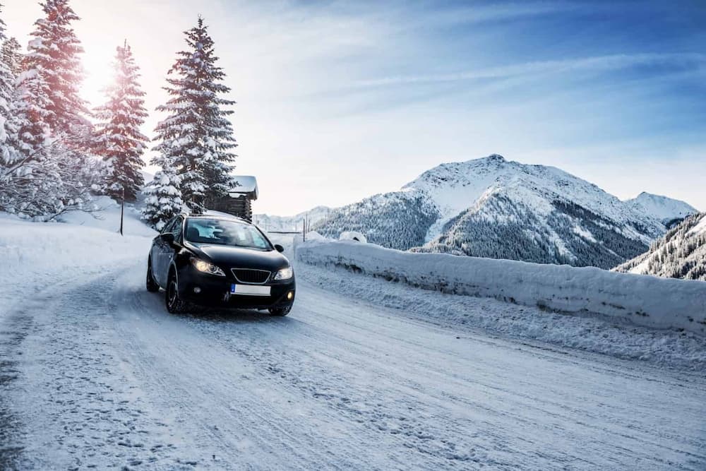 Car driving on a snowy mountain