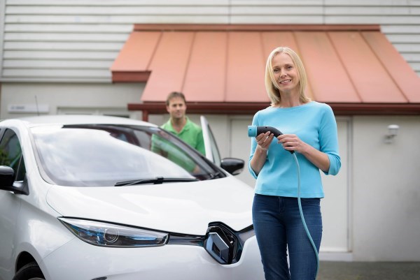 Woman holding charger for car