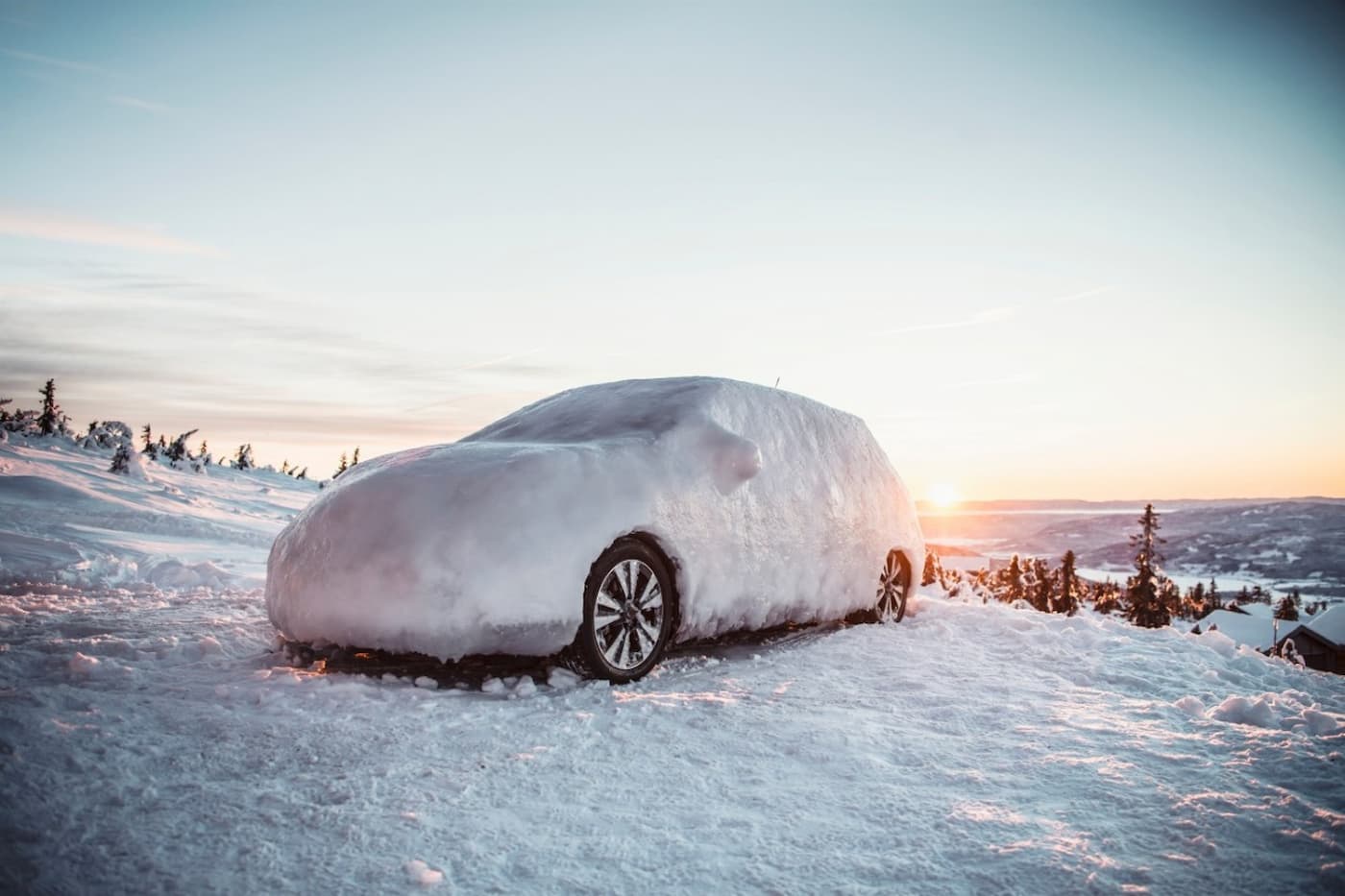 Car covered in snow on a snowy mountain