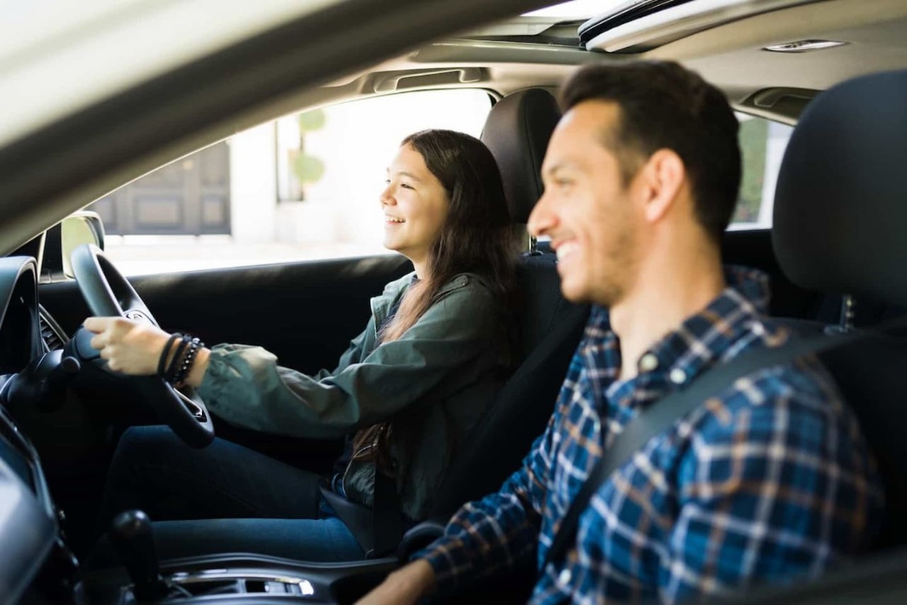 father teaching daughter to drive