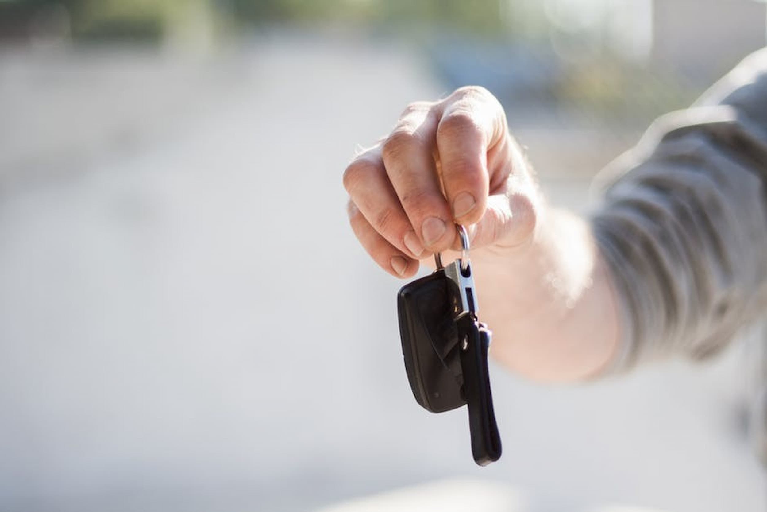 man holding second hand car key